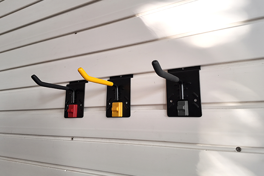 Slatwall four inch single hook, for storing garden lawn mowers and brush cutters