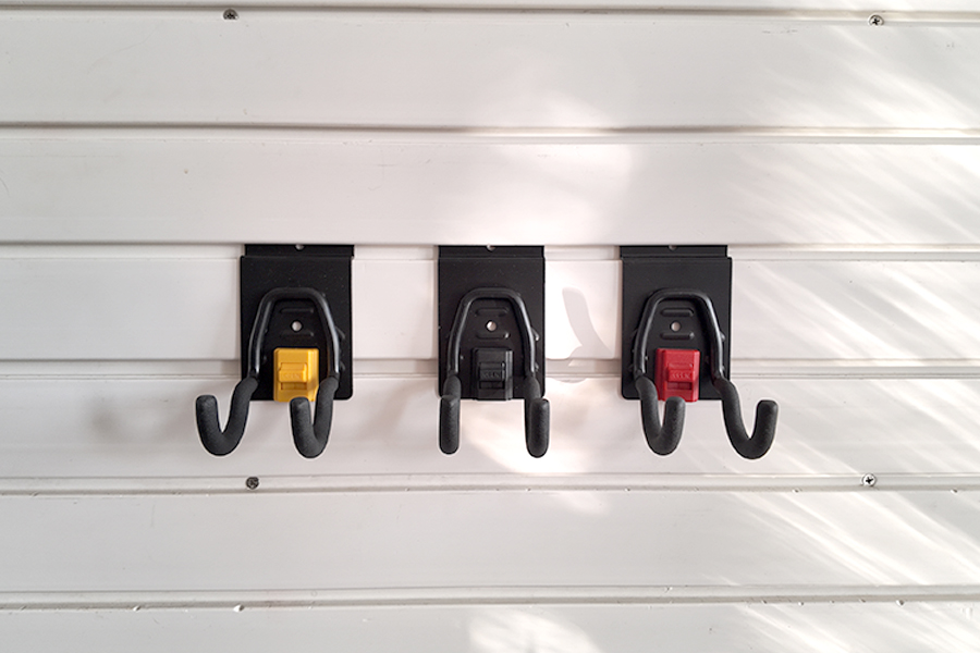 The small round hook on Slatwall is used for small electric tools in garages