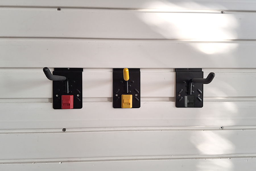 Slatwall four inch single hook, for storing garden lawn mowers and brush cutters