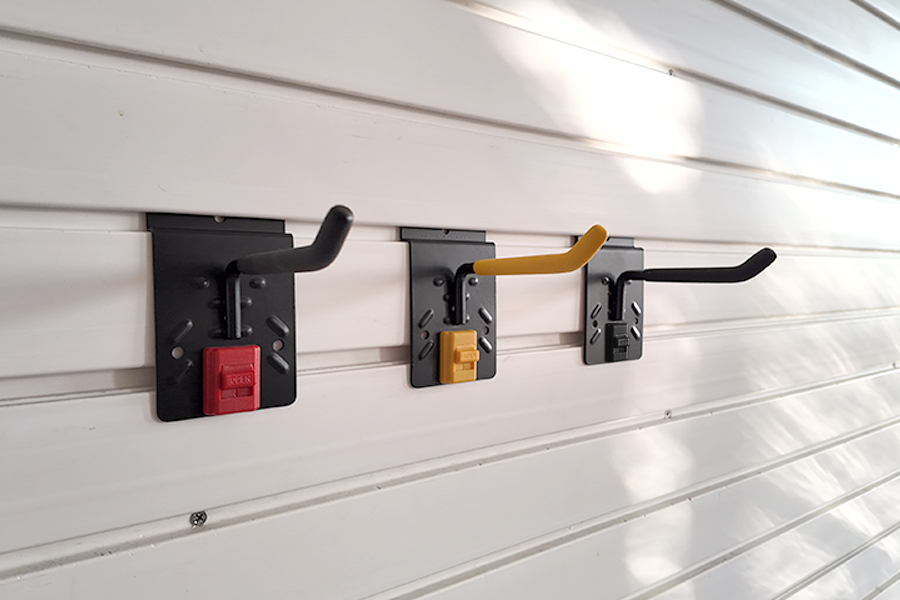 Slatwall four inch single hook, for storing garden lawn mowers and brush cutters